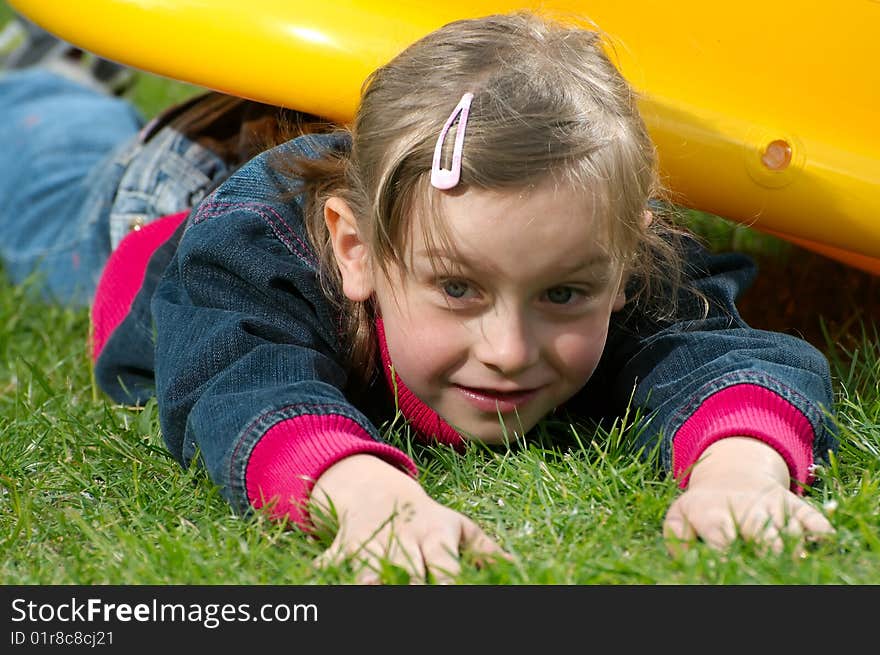 Young girl lies on the grass