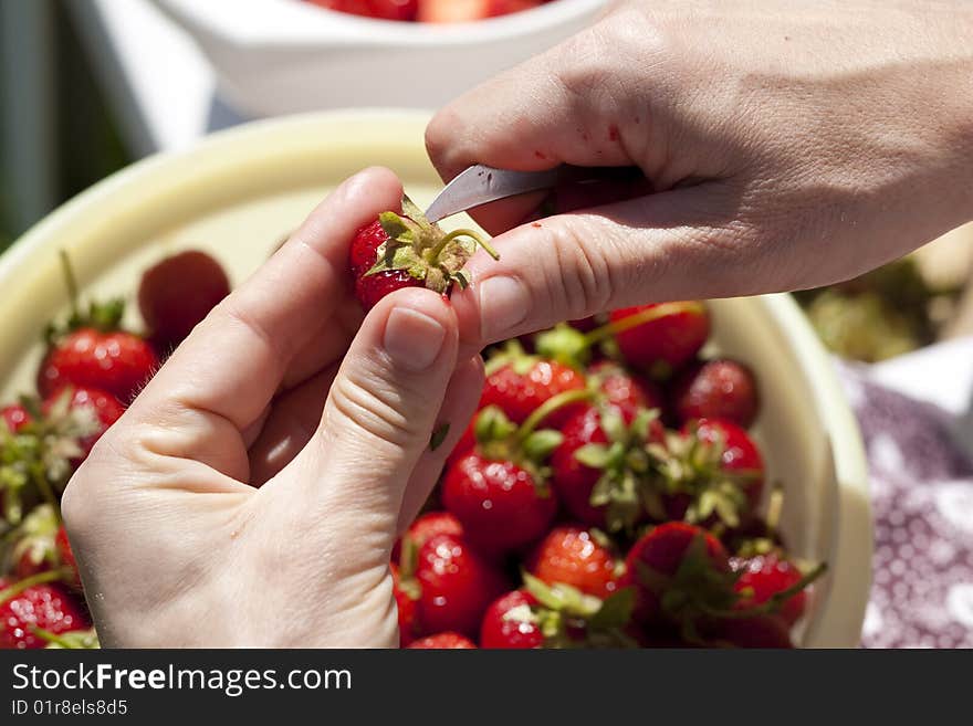 Hulling a strawberry with a kitchen knife