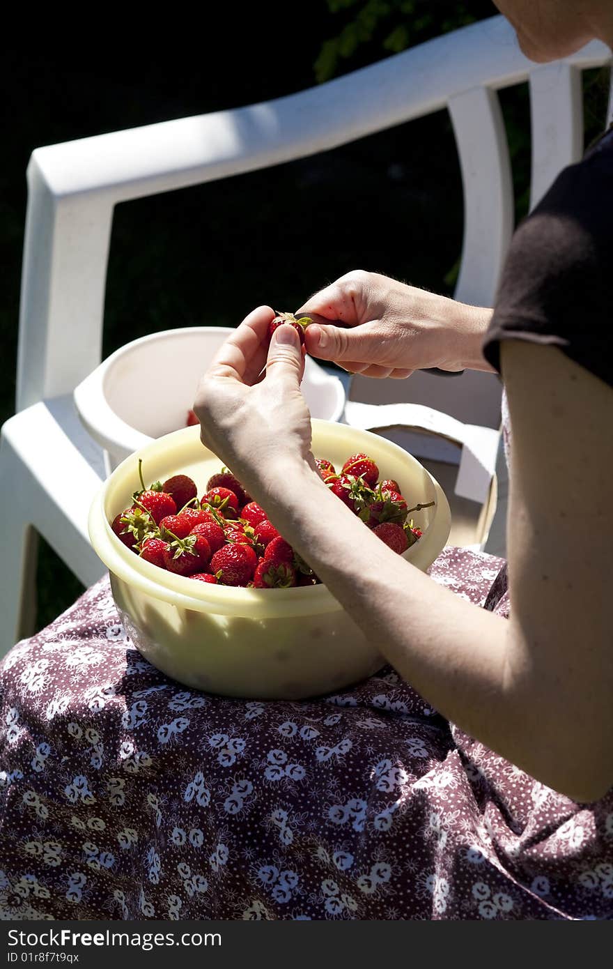 Hulling a strawberry with a kitchen knife