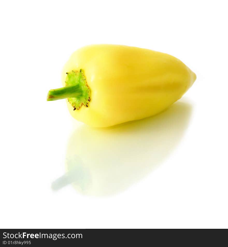 An isolated single pepper with reflection