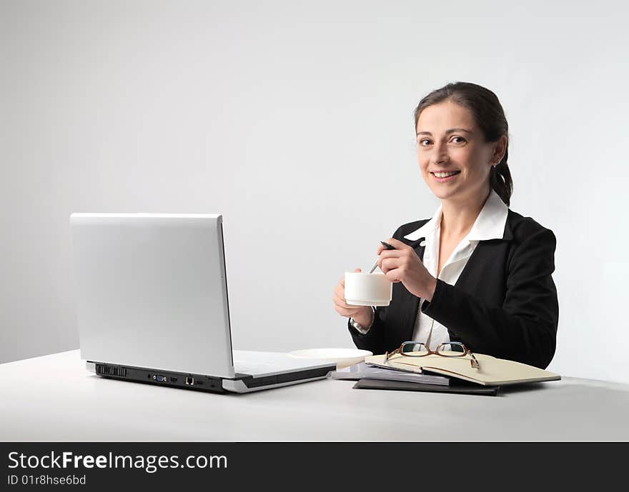 Business woman with cup of coffee and laptop. Business woman with cup of coffee and laptop