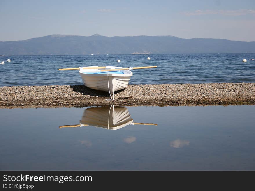 Rowboat bye the lake empty and waiting for passangers