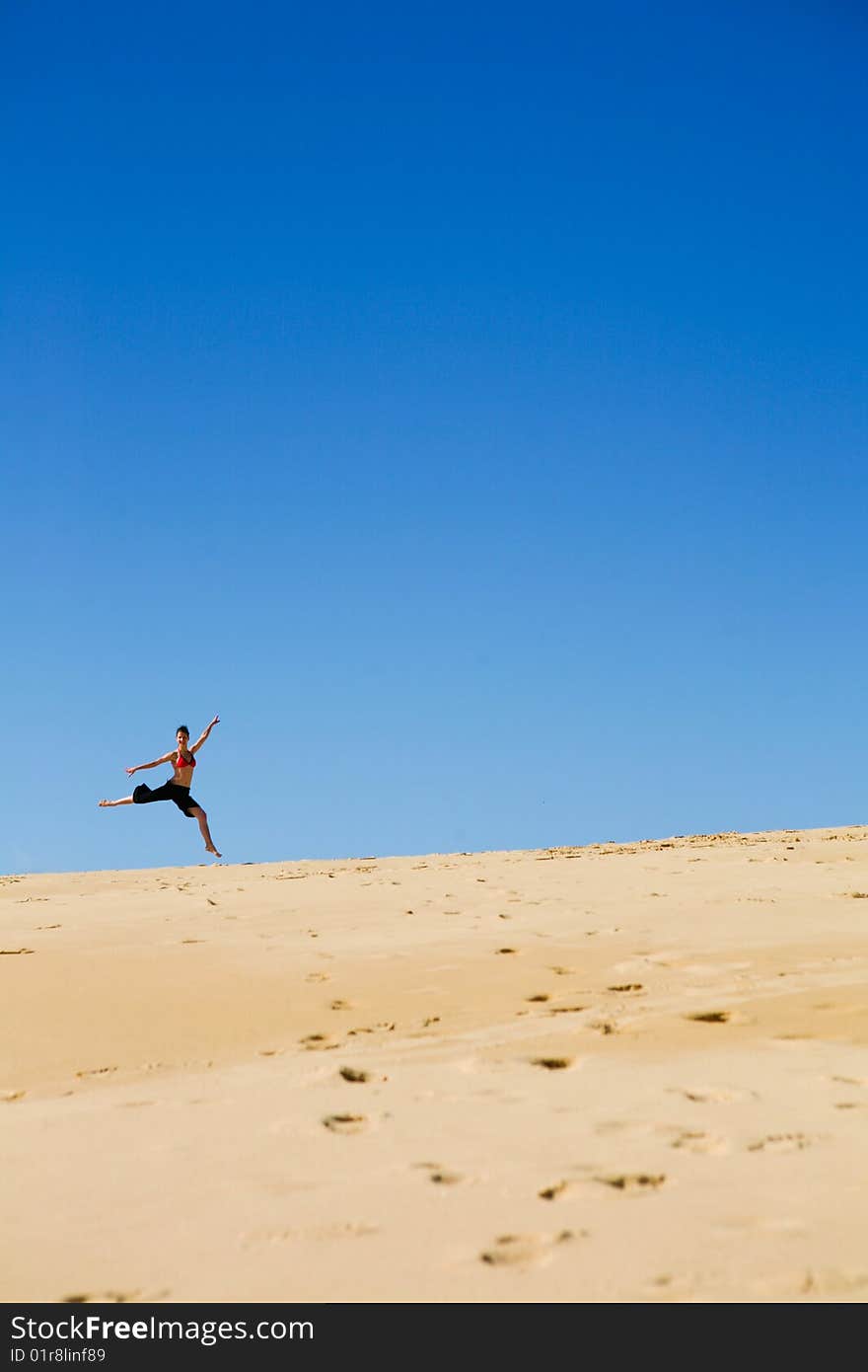 Young Woman Dancing On The Beach