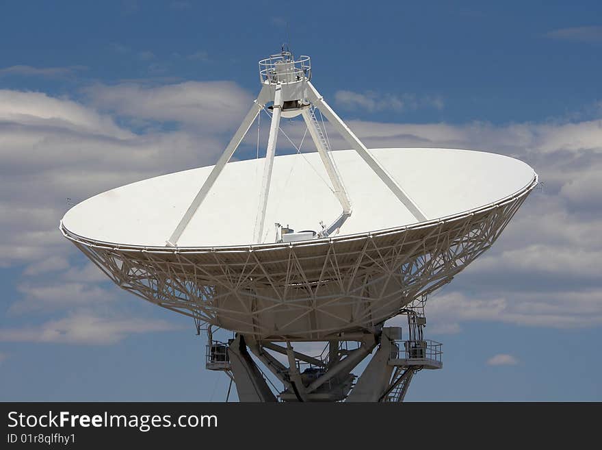 Dish of radio telescope against clouded blue sky. Dish of radio telescope against clouded blue sky.