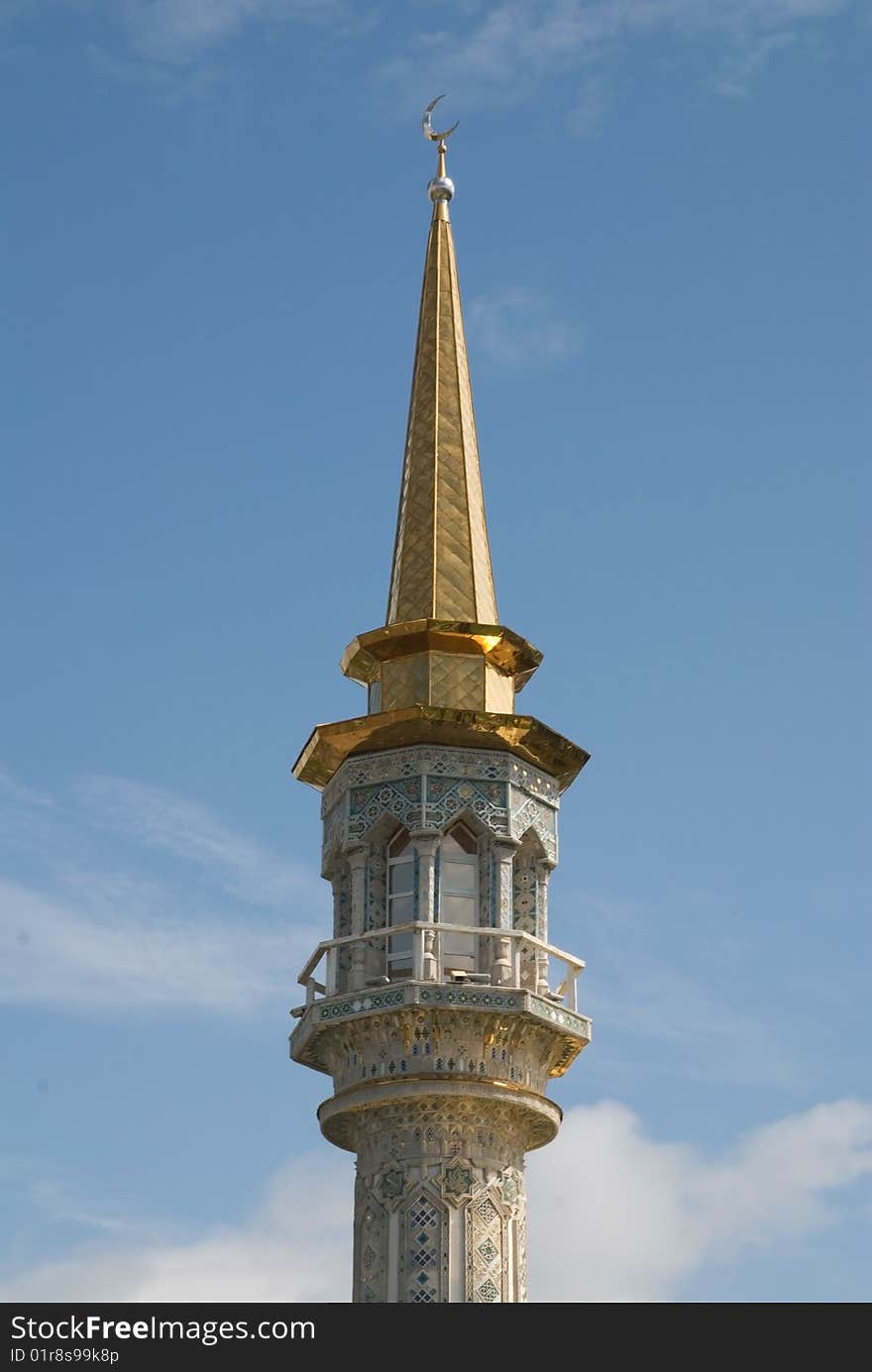 The dome of minaret overpeers on blue sky. The dome of minaret overpeers on blue sky