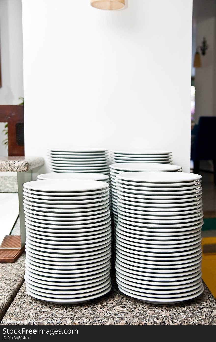 Stack of empty white plates on a table