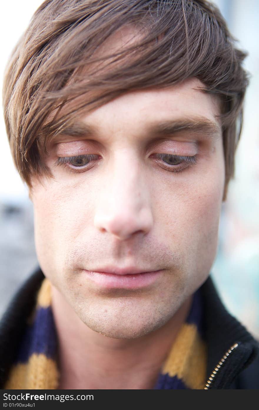 A Close-Up of a young attractive artist type with a scarf and cool haircut