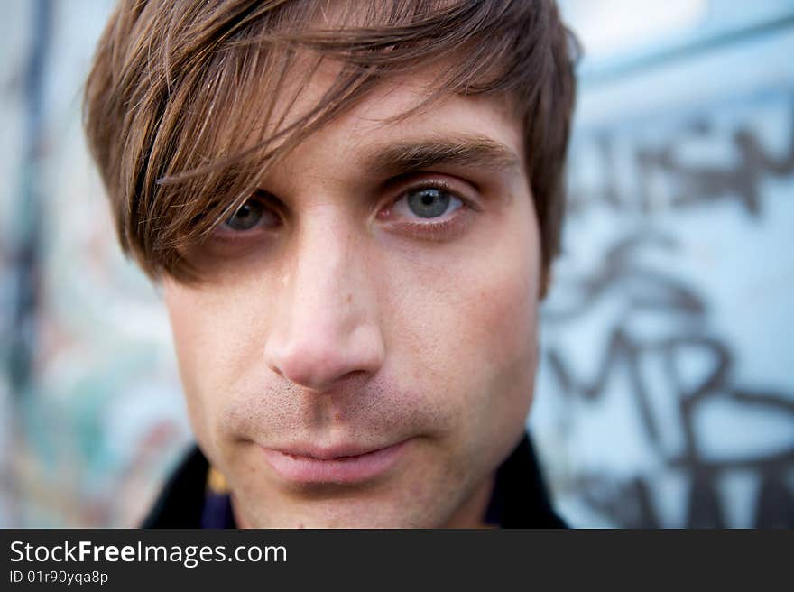 A Close-Up of a young attractive artist type with a scarf and cool haircut