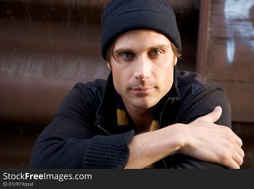 A beautiful young man with a cap and a scarf