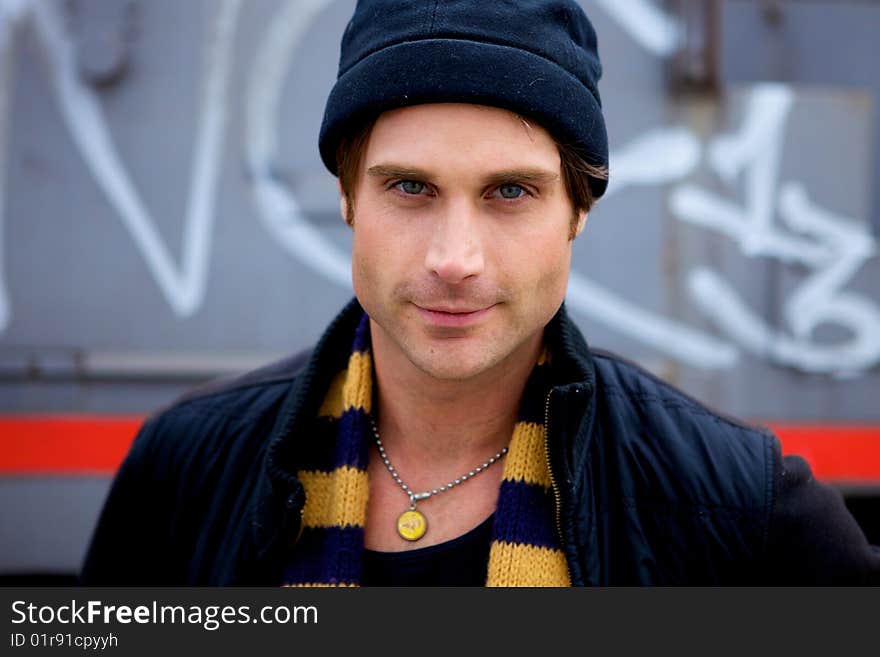 A beautiful young man with a cap and a scarf