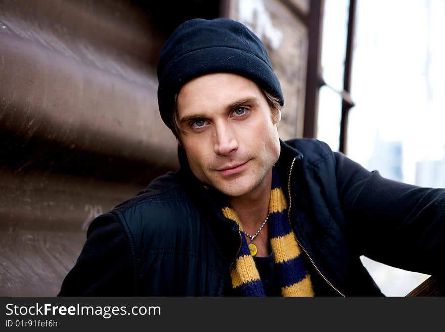 A beautiful young man with a cap and a scarf