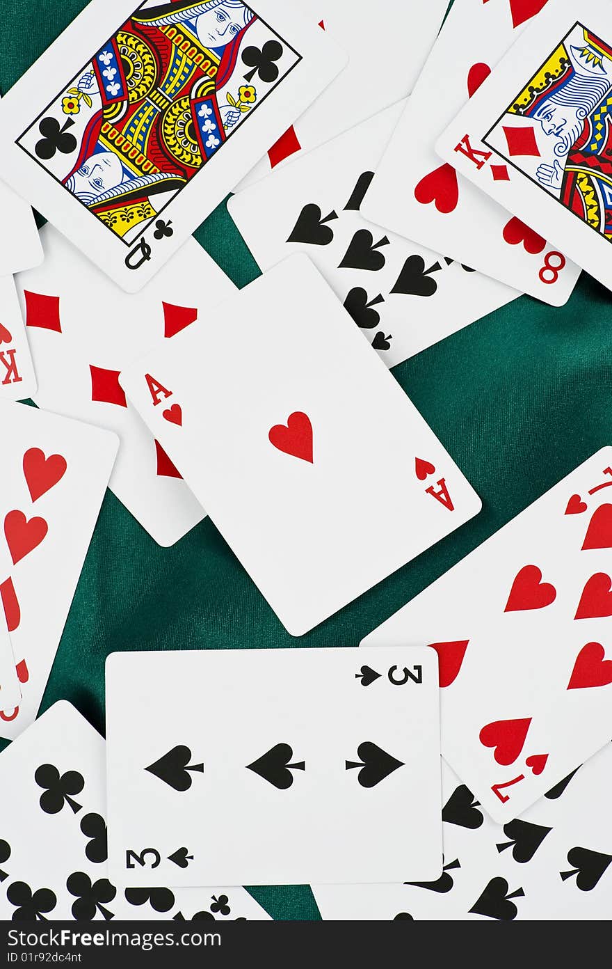 Poker cards on green silk