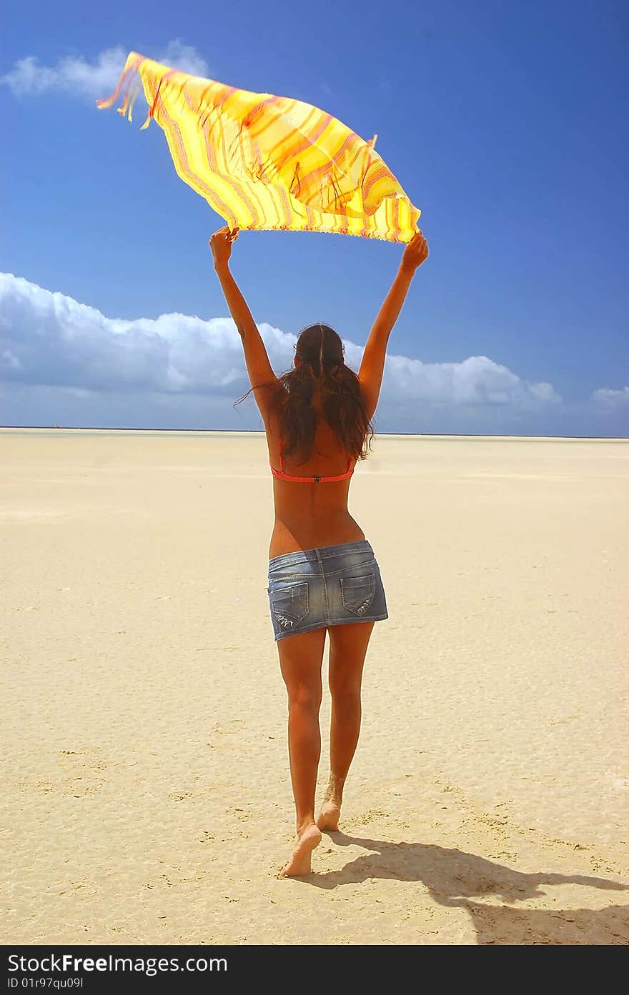 Woman in desert under the sun and keep scarf in her hands above the head. Woman in desert under the sun and keep scarf in her hands above the head