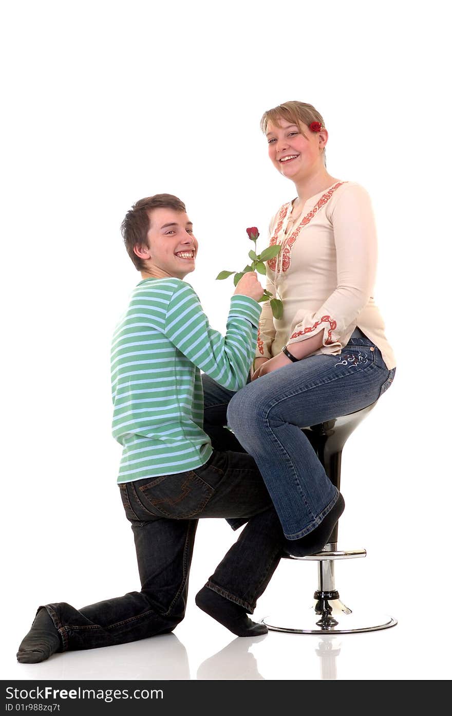 Two casual dressed teenagers , teenage men holding rose flower and woman in love. studio shot. Two casual dressed teenagers , teenage men holding rose flower and woman in love. studio shot.