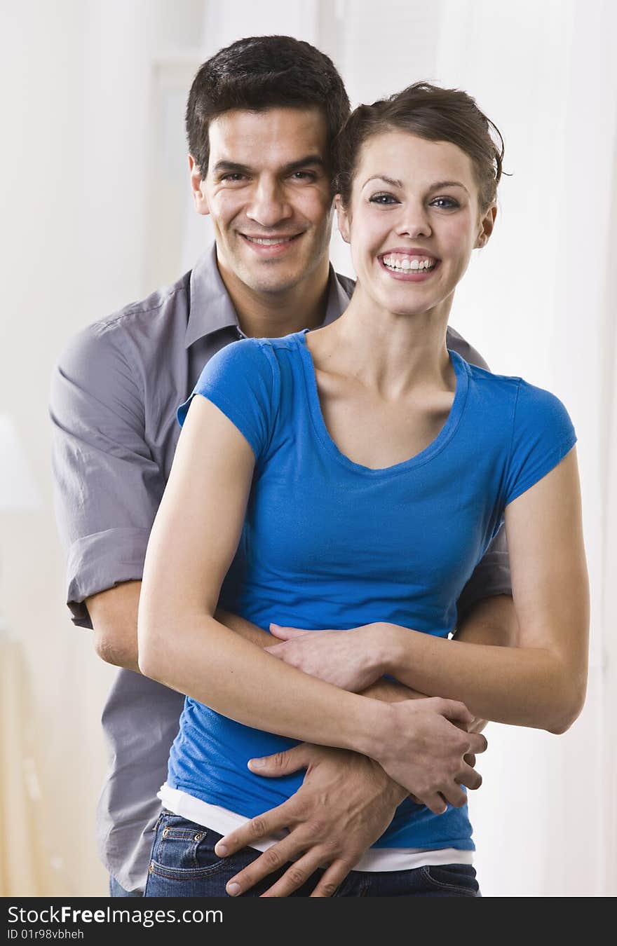 Attractive Brunette couple standing in embrace. vertical. Attractive Brunette couple standing in embrace. vertical