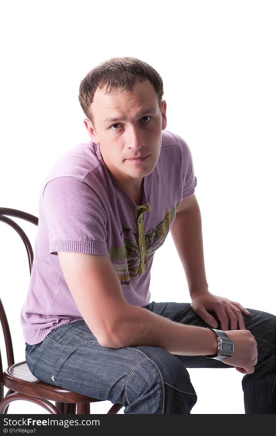 Young man sitting on a bent-wood chair