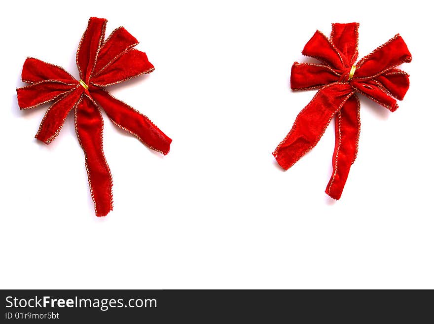 Two velvet christmas bows next to each other isolated on a white background