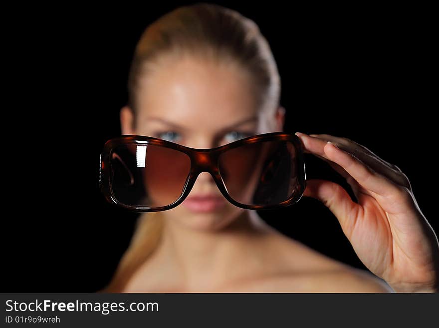 Woman holding sunglasses