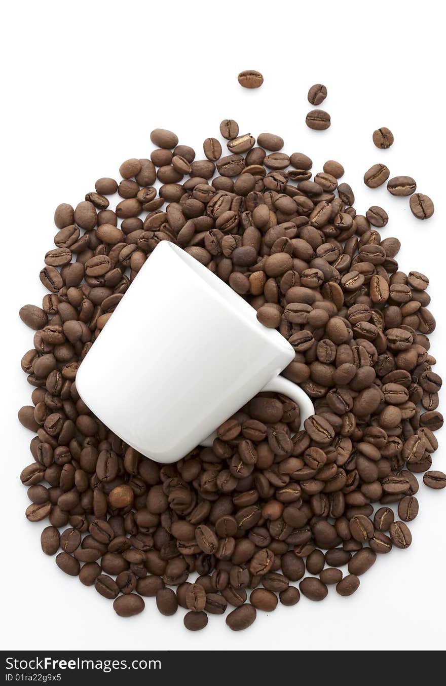 White cup of coffee beans isolated on white background