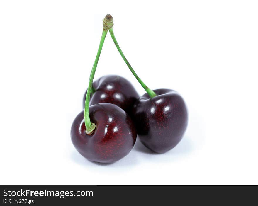 Three cherries on the white background