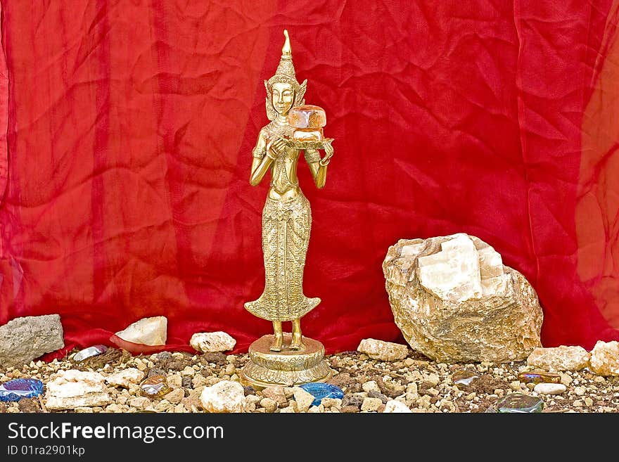 Buddhist statue and minerals colored