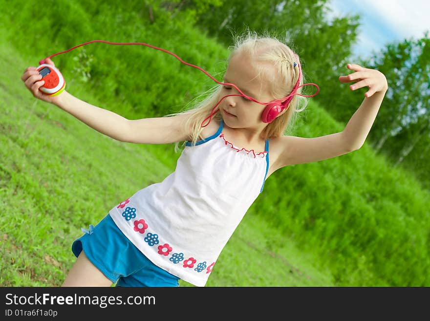 Blonde girl with closed eyes red earphones is listening mp3 player music and dancing. Blonde girl with closed eyes red earphones is listening mp3 player music and dancing