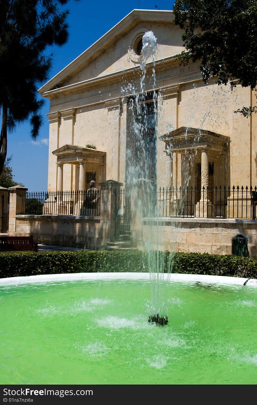 Fountain with historic building in the background