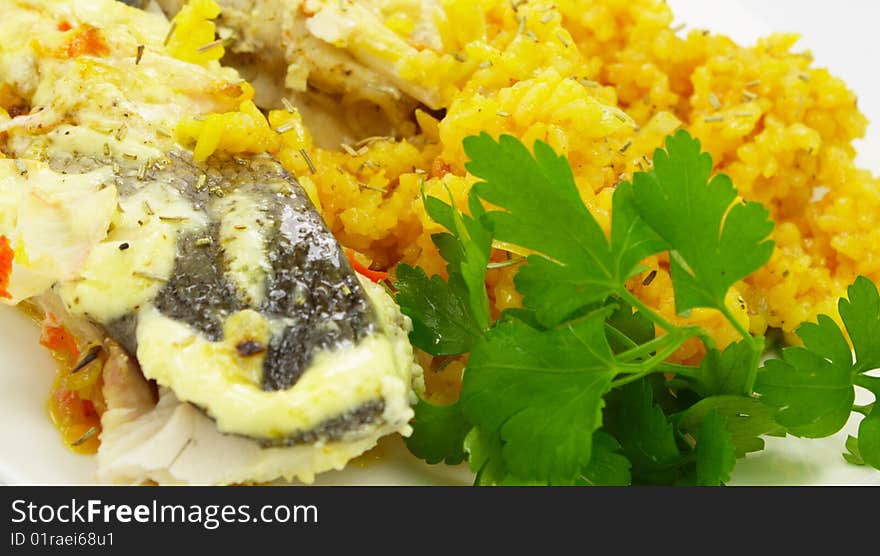 Baked fish with rice and green parsley