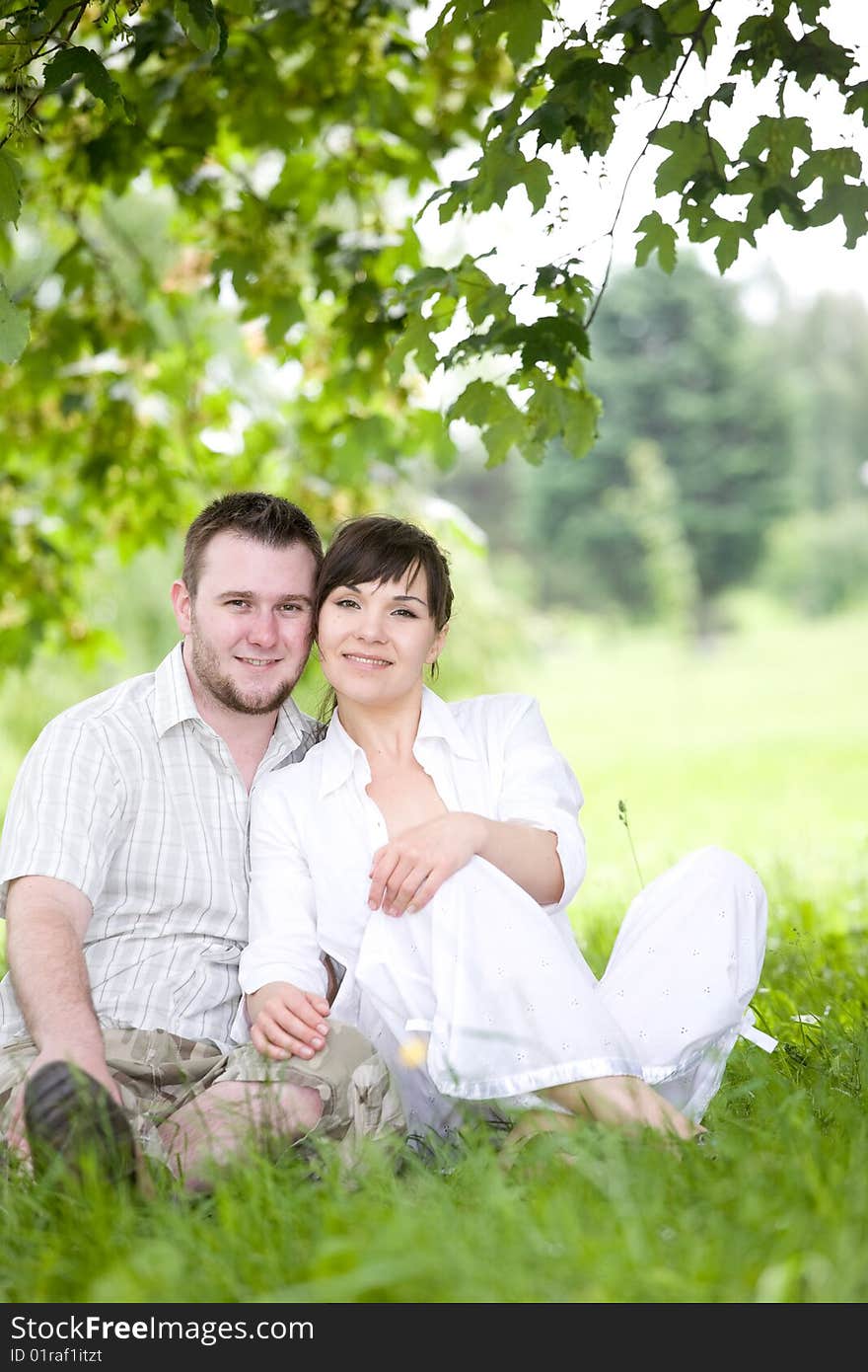 Happy young couple relaxing in park. Happy young couple relaxing in park