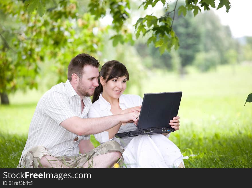 Happy young couple relaxing in park. Happy young couple relaxing in park