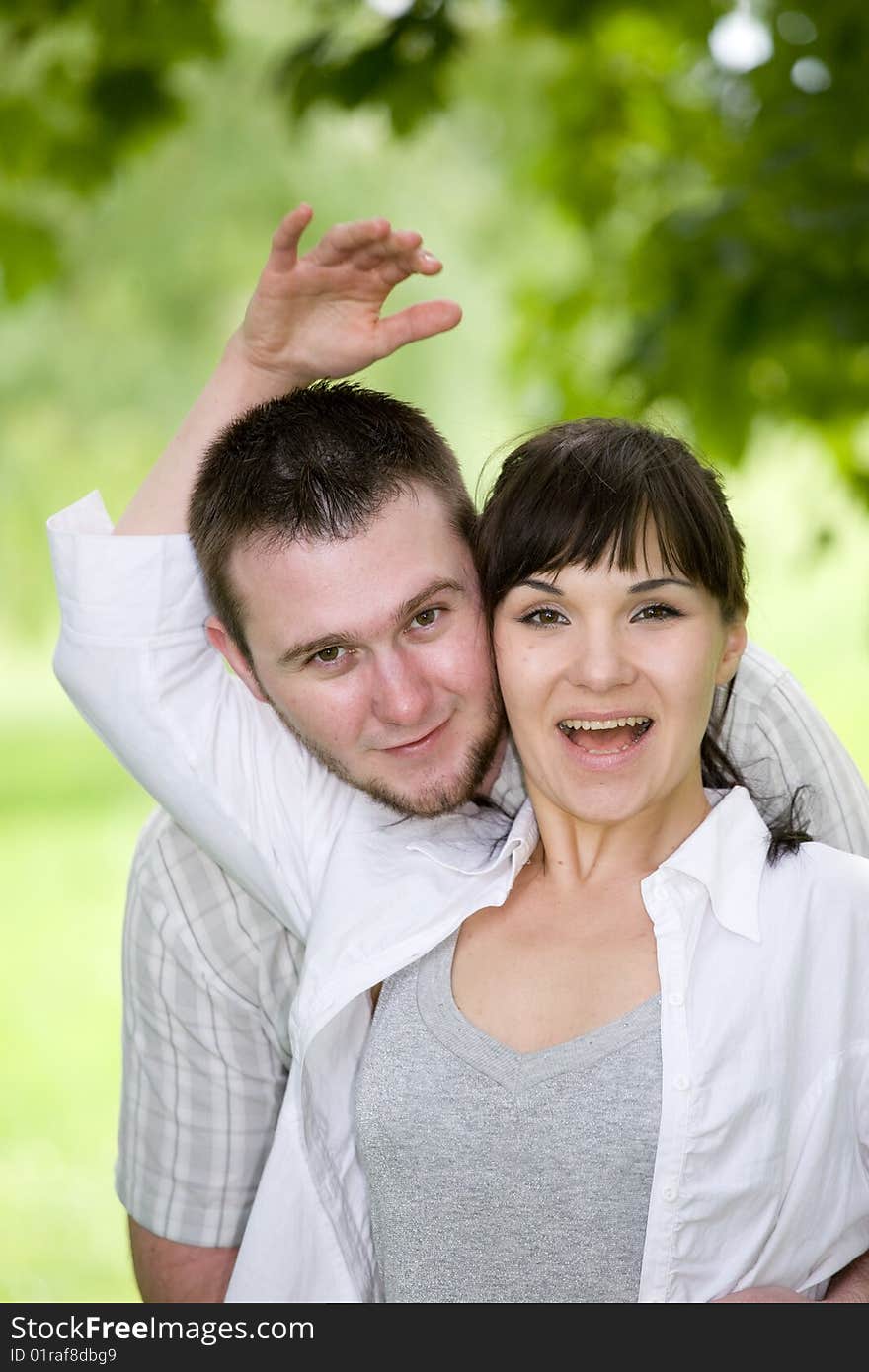 Happy young couple relaxing in park. Happy young couple relaxing in park