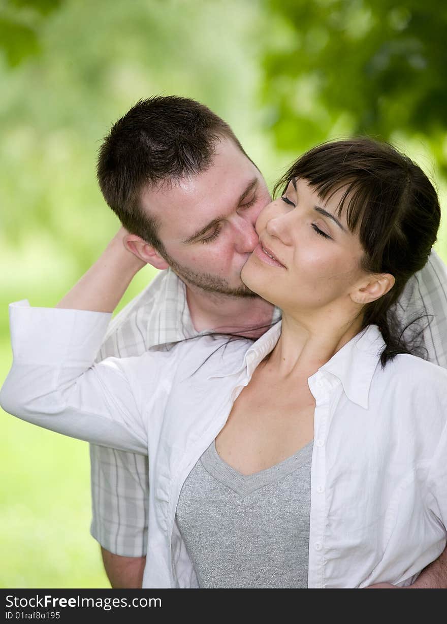 Happy young couple relaxing in park. Happy young couple relaxing in park