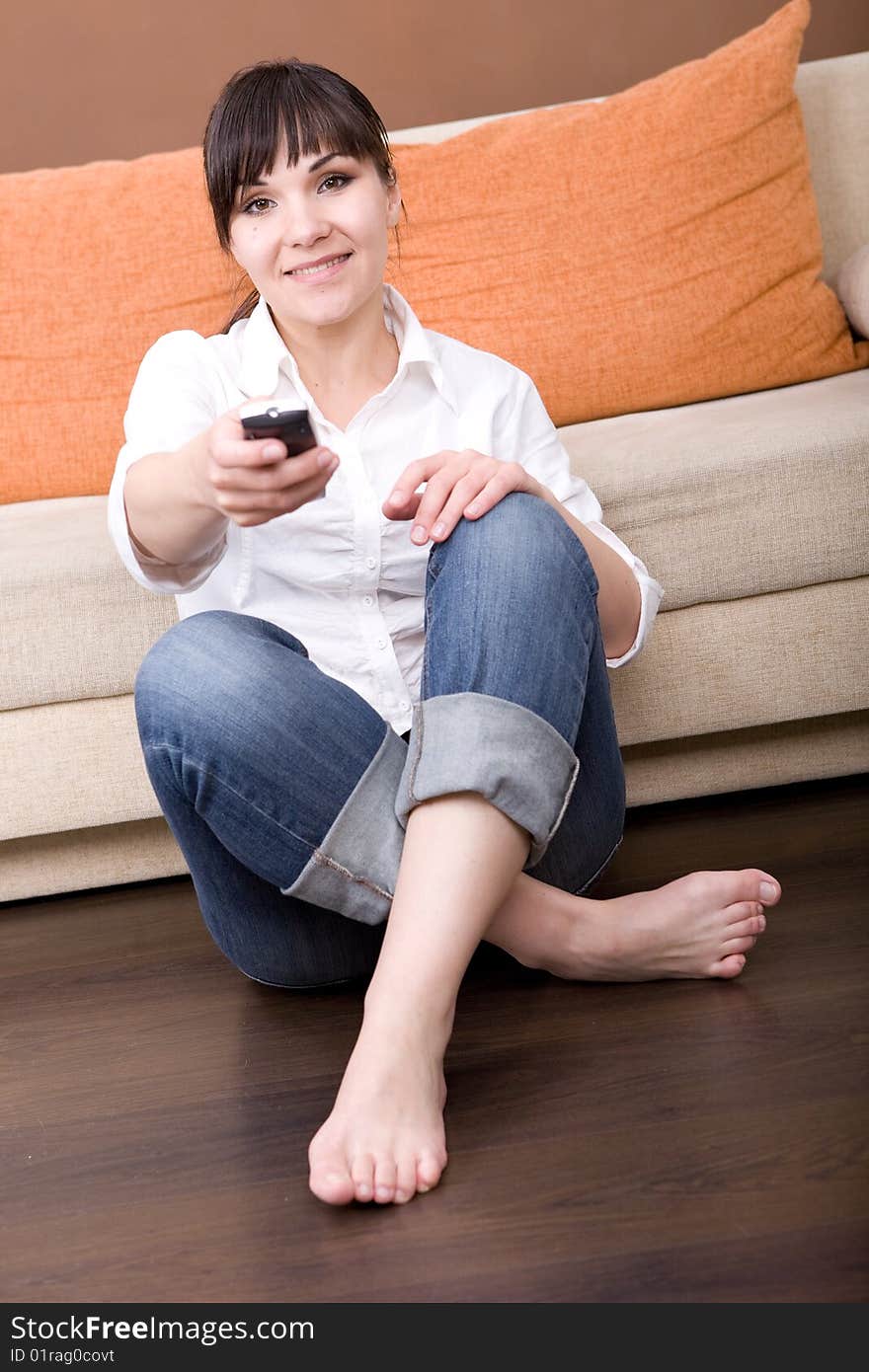 Young brunette woman sitting and watching tv