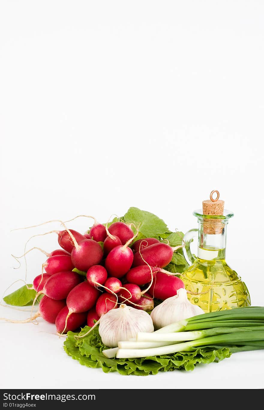 Green vegetables and a bottle of olive oil on the white background. Green vegetables and a bottle of olive oil on the white background