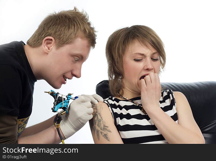 An image of a man drawing adornment  on woman arm