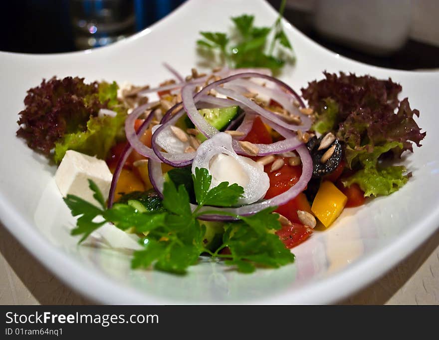 Healthy Greek salad with olives, tomatoes, cucumber, red onion, and cheese feta. Healthy Greek salad with olives, tomatoes, cucumber, red onion, and cheese feta.