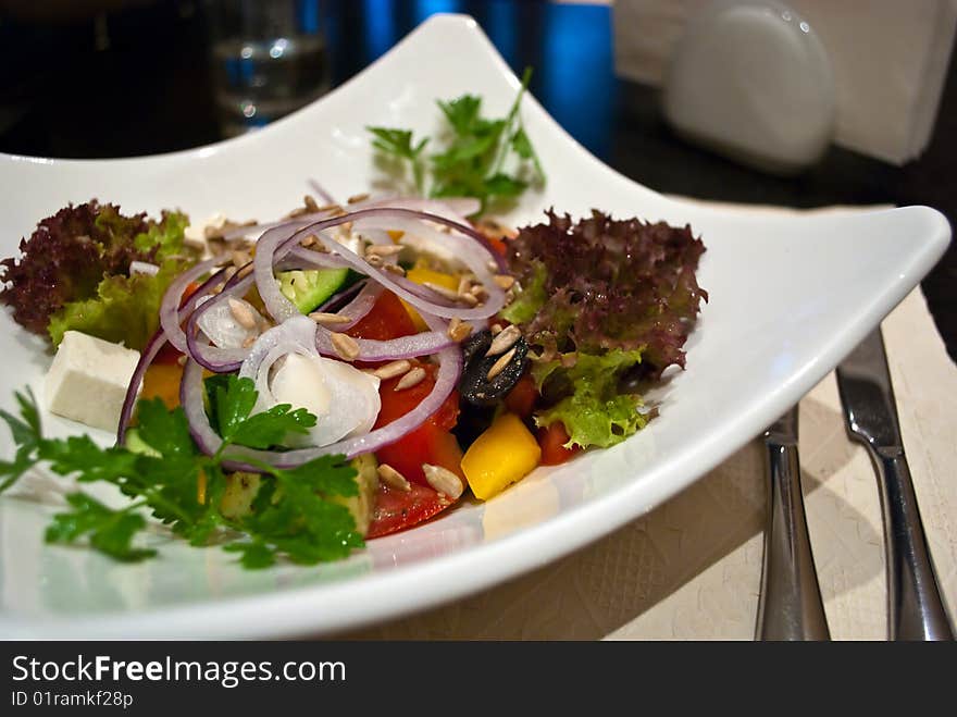 Healthy Greek salad with olives, tomatoes, cucumber, red onion, and cheese feta.