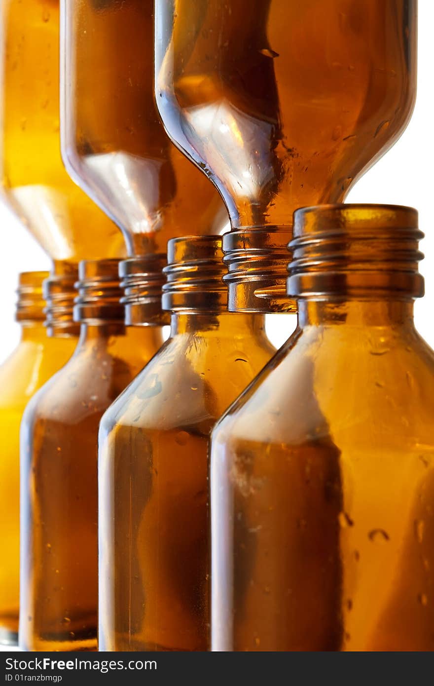 Two numbers of small brown bottles placed against each other on isolated background. Two numbers of small brown bottles placed against each other on isolated background