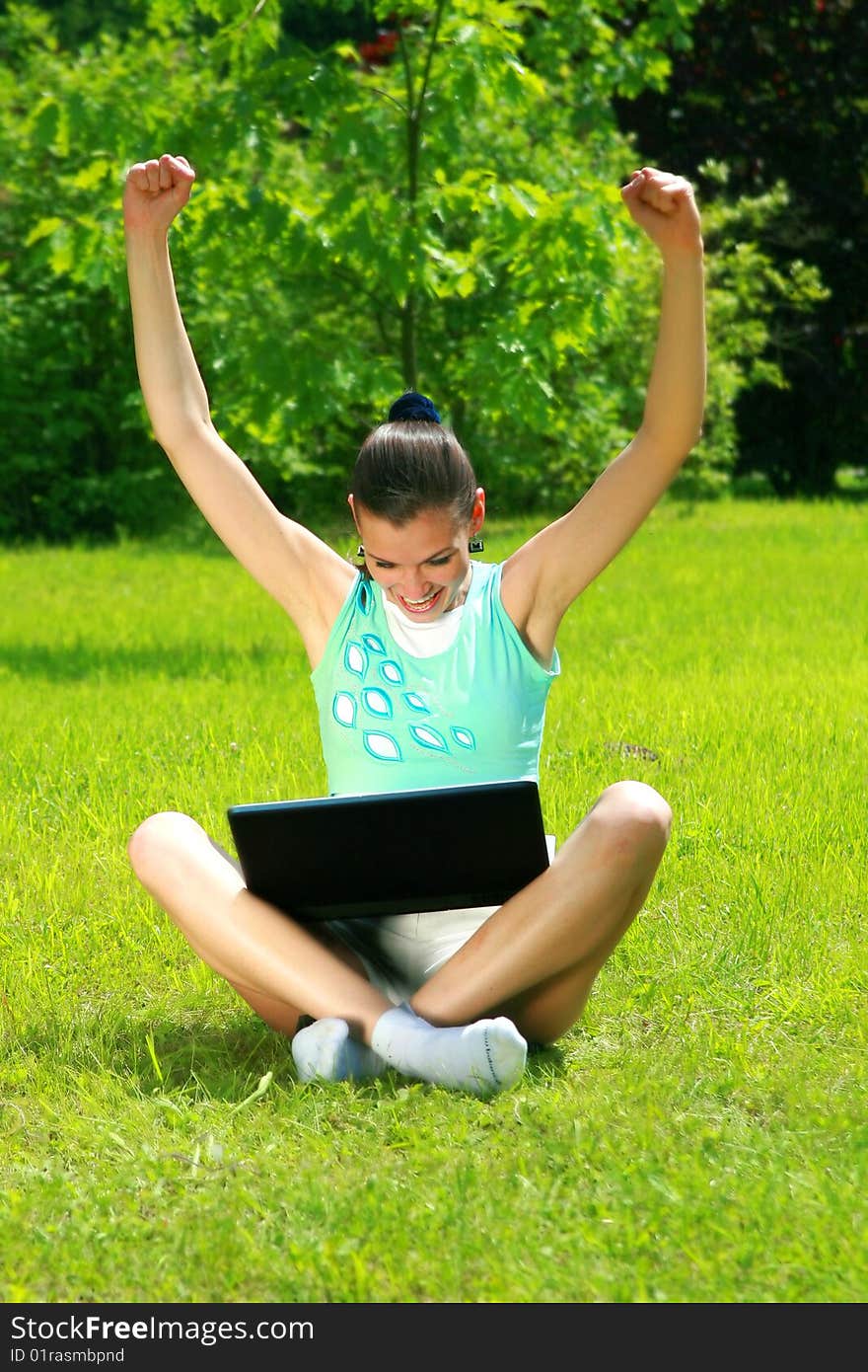 Young woman on a nature with the laptop