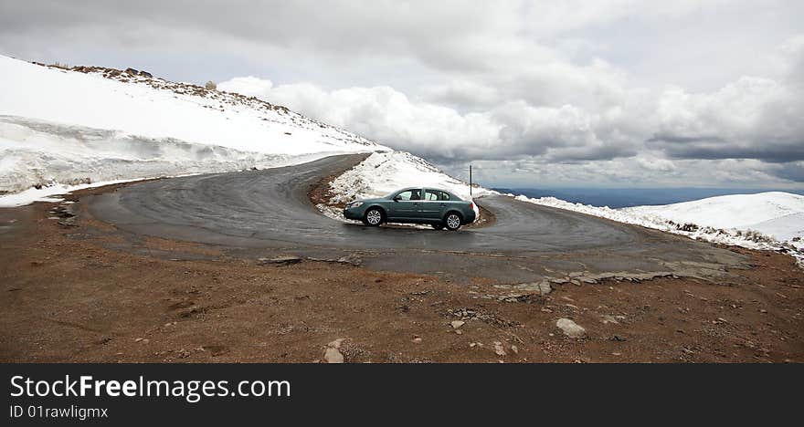 Car Going Around A Hairpin Turn On Mountain Road