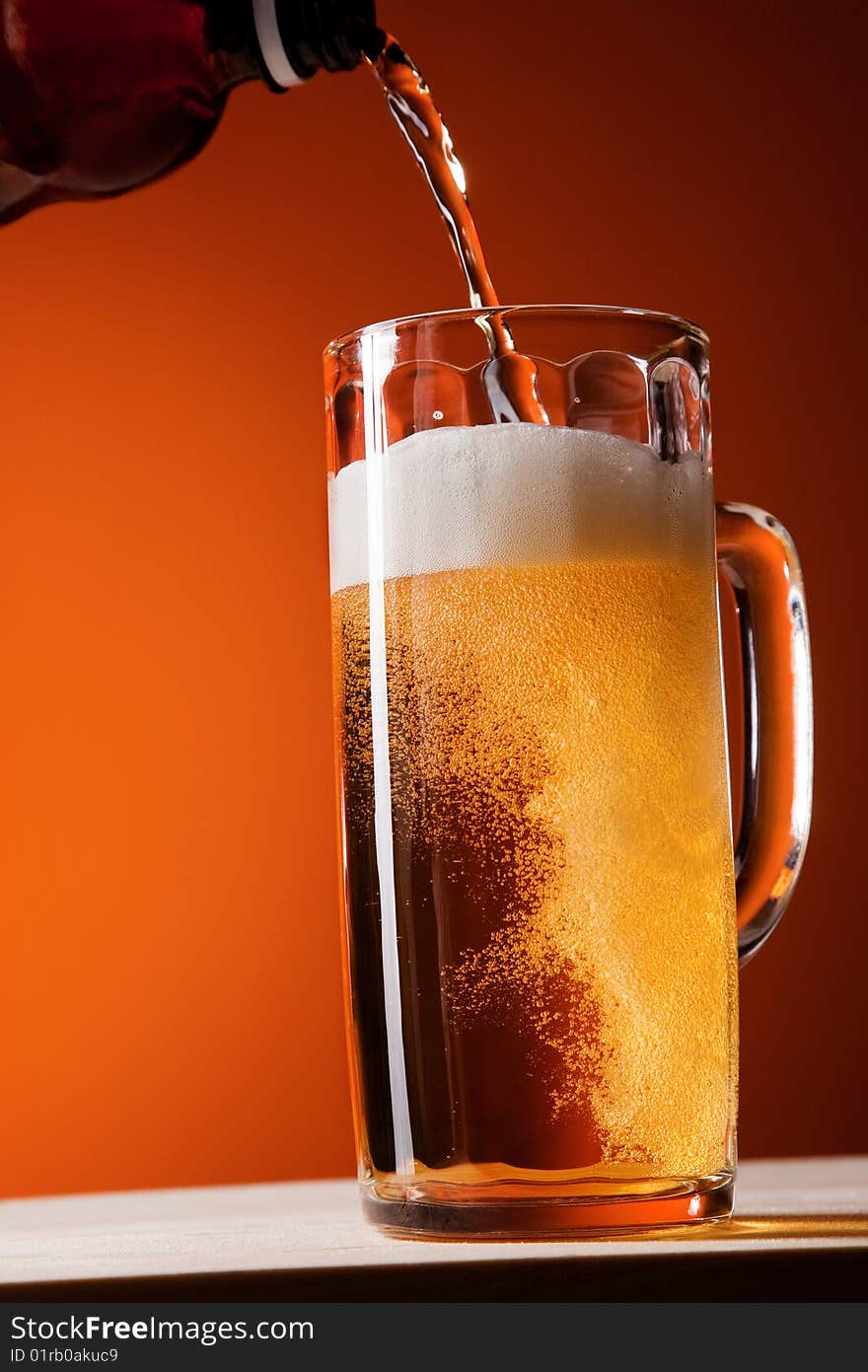 Big mug with beer isolated in motion. Big mug with beer isolated in motion