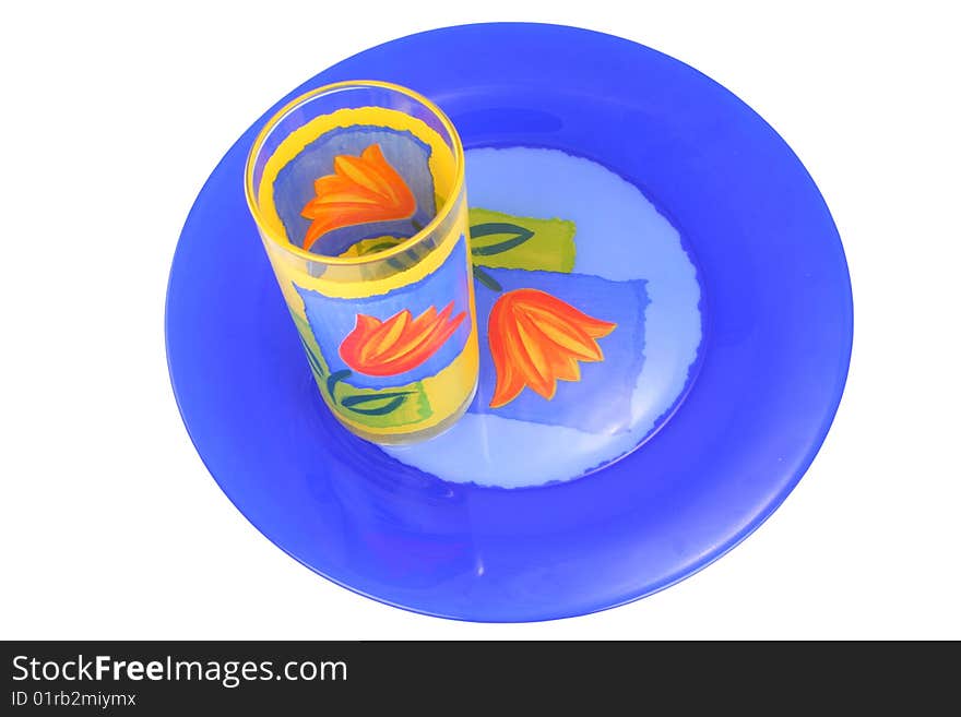 Plate and glass of dark blue and yellow colour on a white background