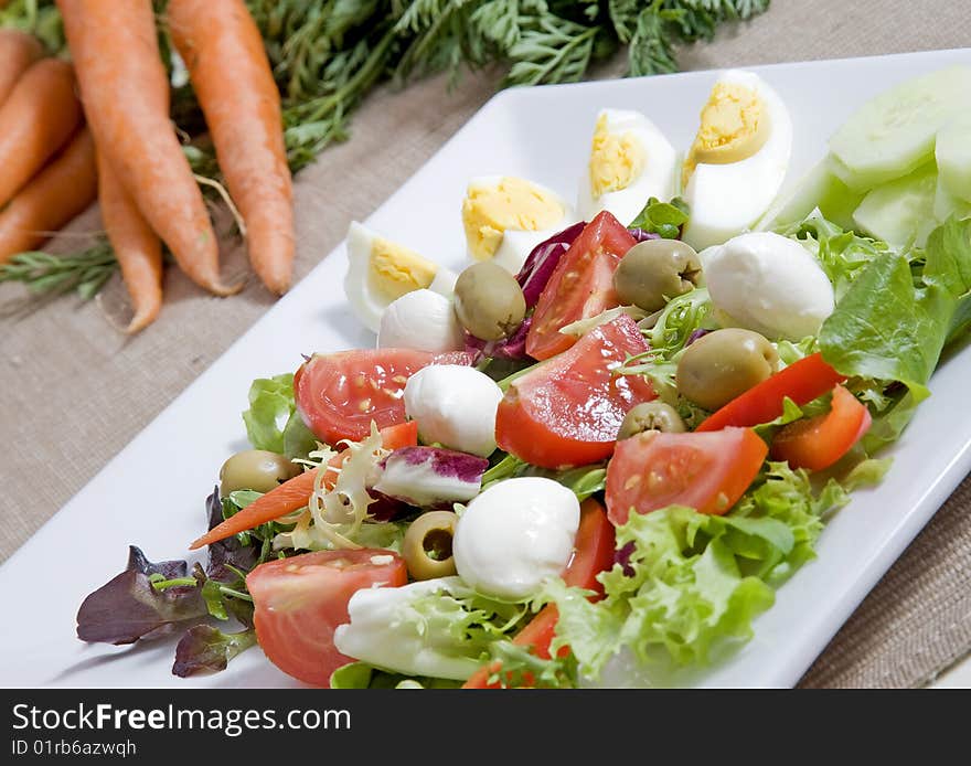 Healthy salad with eggs cherries and olives