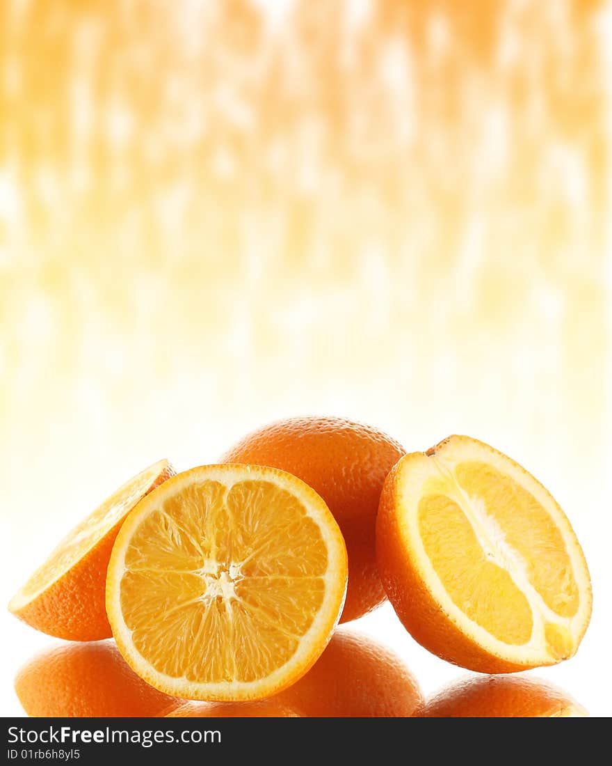 Group of oranges on mirror surface with abstract background