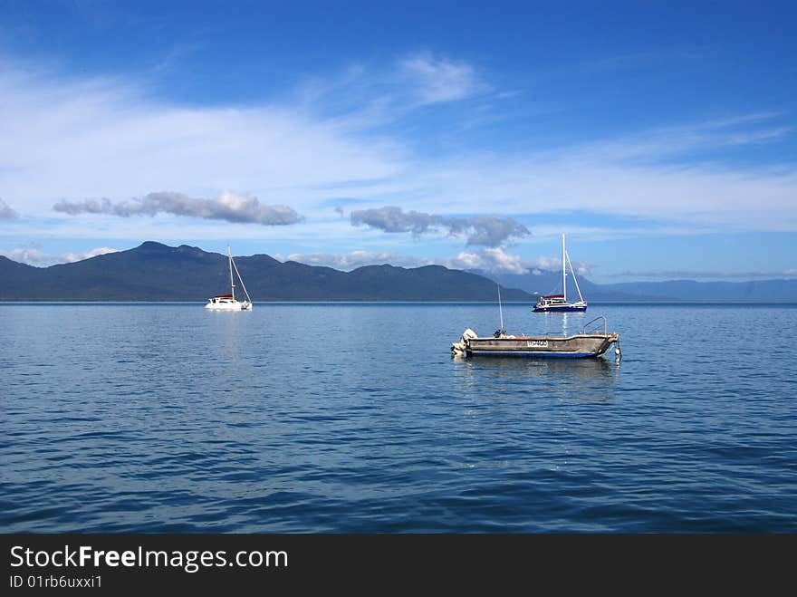 Boats moored off the coast of Hinchinbrook Island in northern Queensland, Australia.