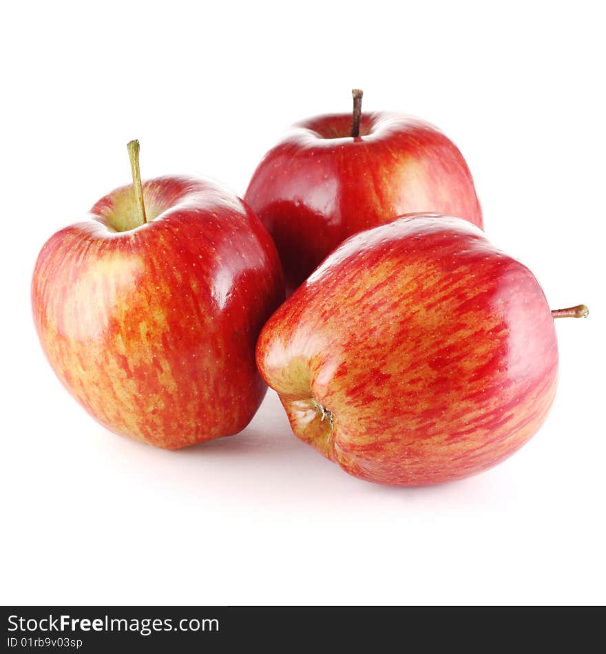 Three red shiny apples isolated on white