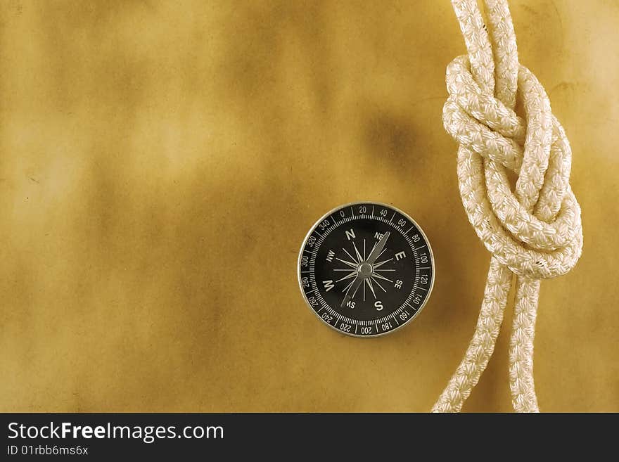 Compass with rope on acient paper. Compass with rope on acient paper