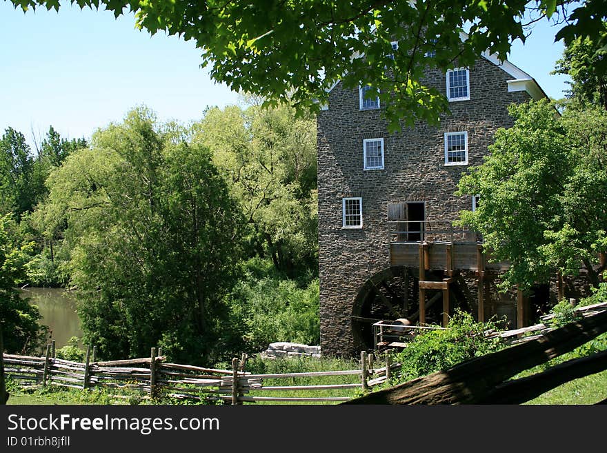 The old building of watermill on the beach of pond. The old building of watermill on the beach of pond