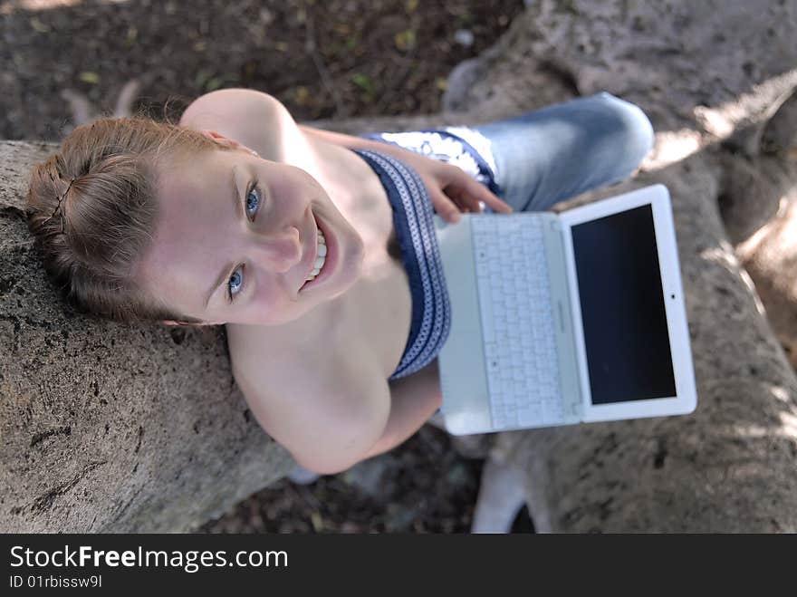 Beautiful Young Girl Working With Laptop In Tree