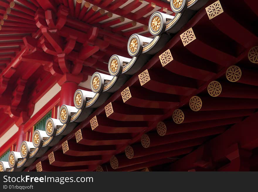 An illuminated roof's edge in a Buddhist temple build in classical Chinese architectural style, in Chinatown, Singapore. An illuminated roof's edge in a Buddhist temple build in classical Chinese architectural style, in Chinatown, Singapore